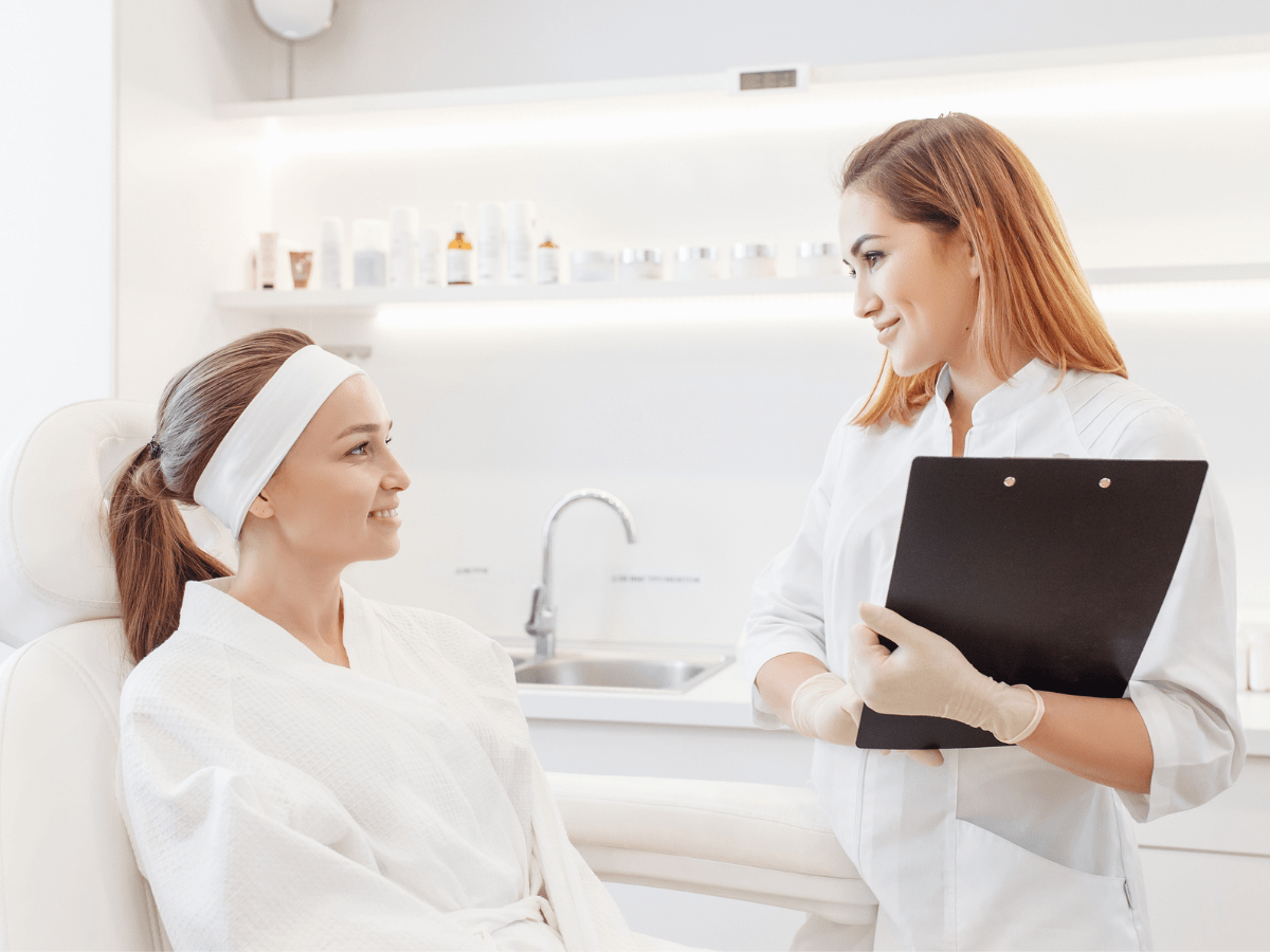 A Valmére Skin Science practitioner speaking with a client.
